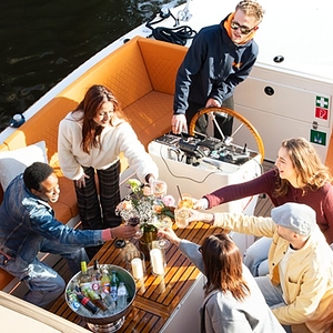 Open boat cruise with drinks people saying cheers having fun