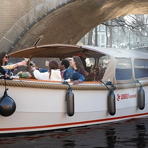 Lovely cruises people going under bridge sun