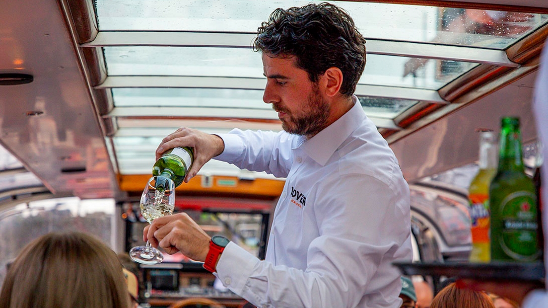 Serving drinks on board a canal cruise