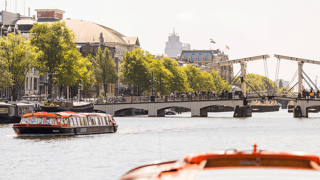 Lovers boats in front of the Skinny Bridge Amsterdam preview 1386x1042