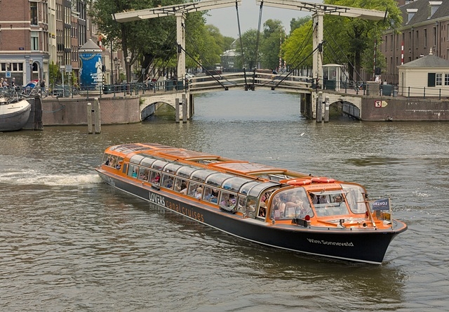 Lovers canal cruise at wooden bridge amsterdam boat